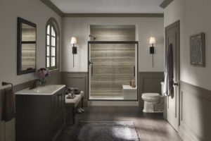 Bathroom with a grey walk-in shower enclosure, vanity, and tile floor
